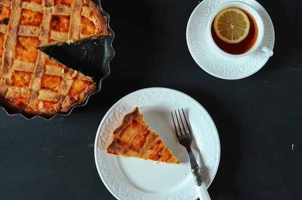 Slice of homemade pie on white plate with provance silverware — Stockfoto