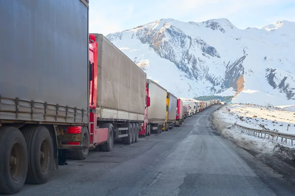 trucks with turkish cargo waiting on a road curve in front of the russian border