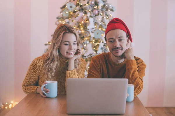 Happy young couple making video call with laptop, greeting their family with Christmas or New Year holidays. — Stock Photo, Image