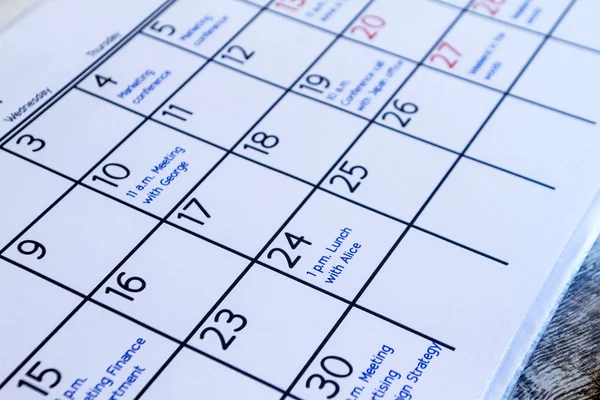 Checking monthly activities in the calendar — Stock Photo, Image