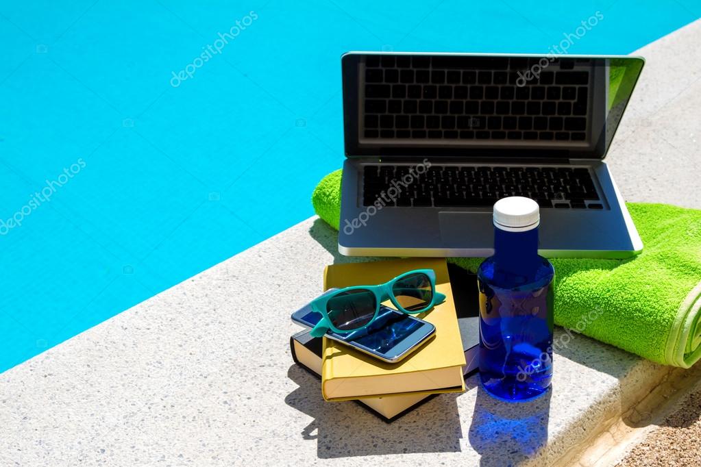 Surfing in the internet near the swimming pool	