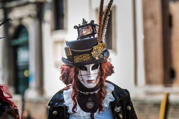 Venice - February 6, 2016: Colourful Carnival mask through the streets of  Venice