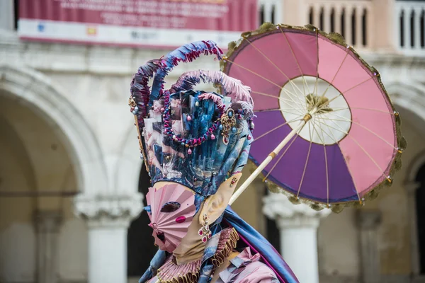 Venice, Italy - February 13, 2015: A wonderful mask participant of the annual carnival celebrations