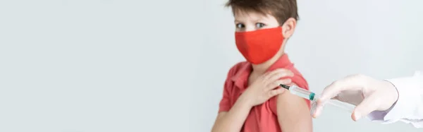의료용 마스크를 어린이는 세계적 유행병인 코로나 바이러스에 접종을 받는다 주사기로 — 스톡 사진