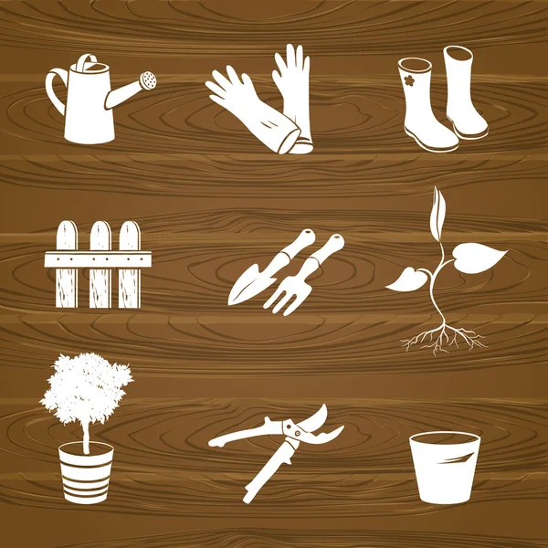 Zahradní nástroje ikony na dřevo pozadí — Stockový vektor