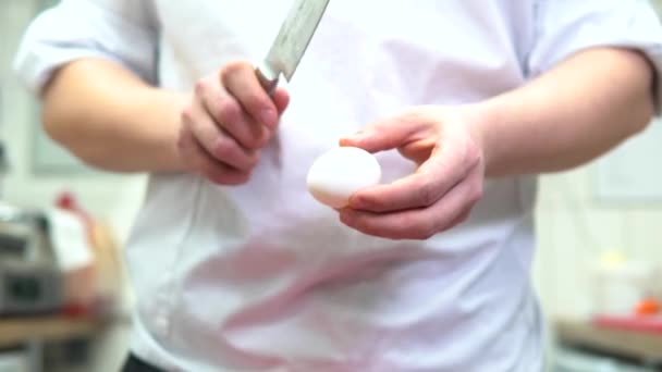 Experienced Male Chef White Uniform Cracking Egg Knife Hands Light — Stock Video