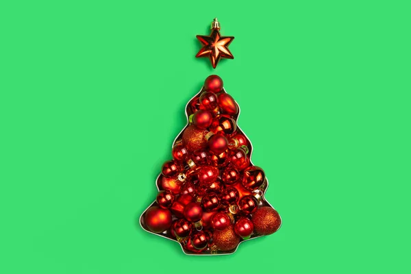 Rote Weihnachtskugeln Liegen Form Eines Weihnachtsbaums Auf Grünem Hintergrund Weihnachtskarte — Stockfoto