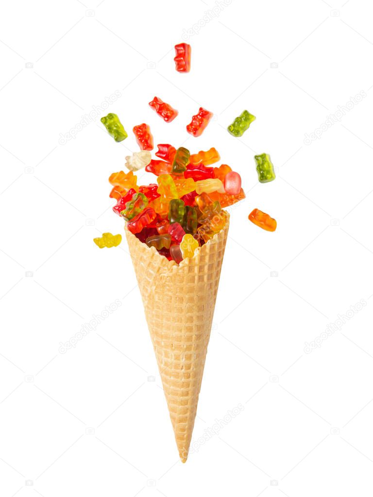 Waffle cone with gummies. Marmalade bears. Favorite children's sweets. White isolated background. Copy space.