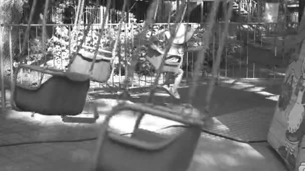 Vintage photography of a childrens carousel. Monochrome motion picture. — Stock Video