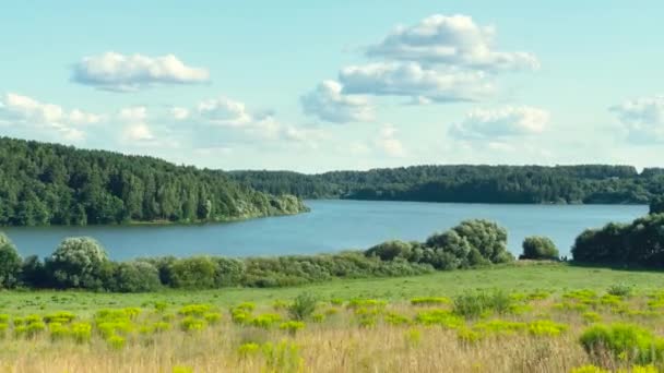 View of flying clouds over the lake time-lapse footage.The clouds fly away into the distance above the water. — Stockvideo