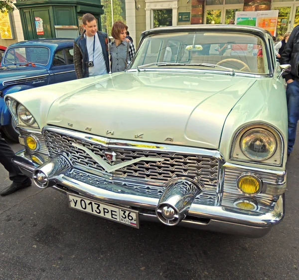 Townspeople em torno do carro de luxo soviético de 1960-70 GAZ M13 Chaika — Fotografia de Stock