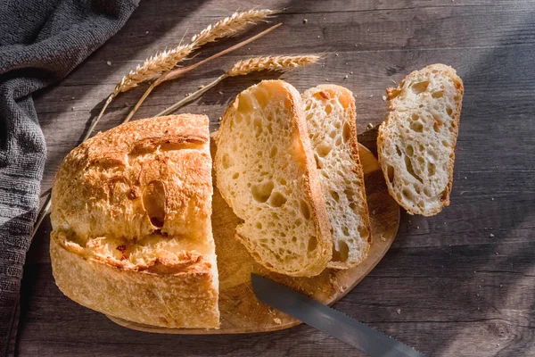 Olika rustika bröd på en träskiva. Friska livsmedel och odlingskoncept — Stockfoto
