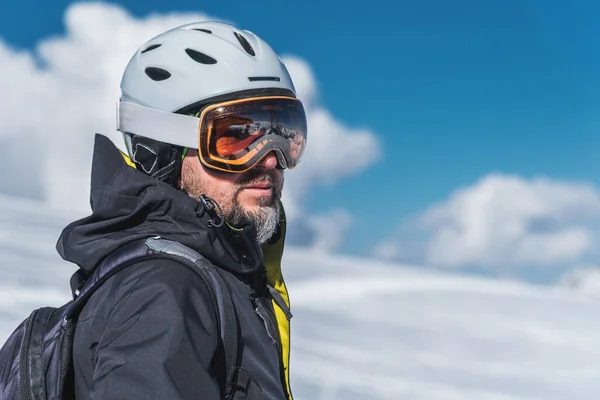 Un uomo con gli sci si erge in cima alle montagne godendo il paesaggio. Sci alpino, estremo relax — Foto Stock