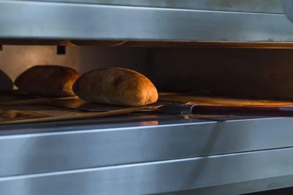 Ciabatta bread in an industrial oven. Making craft bread at the bakery