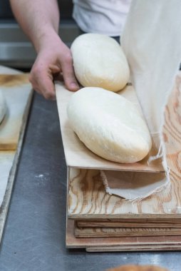 Fırıncı ekmek yapıyor, erkek eli, hamur yoğuruyor, manto pişiriyor. Küçük fırın kavramı, geleneksel ekmek sanatı.