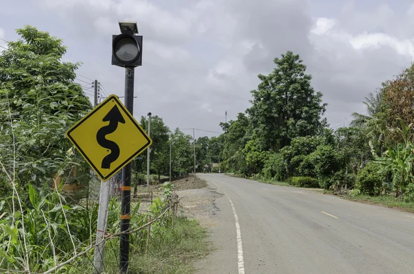 Winding road sign in yellow and black — Stock Photo, Image