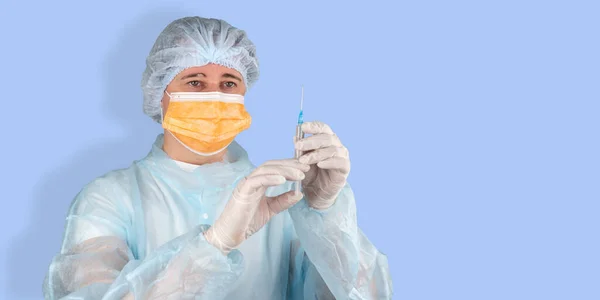 female doctor or scientist in mask with syringe over blue background. woman with an injection syringe. nurse does the vaccination. concept of public health and mass vaccination of the population