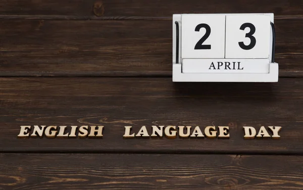 April 23, date on the calendar. English Language Day. Handmade wood cube with date month and day. Wooden letters on wooden background. english alphabet.