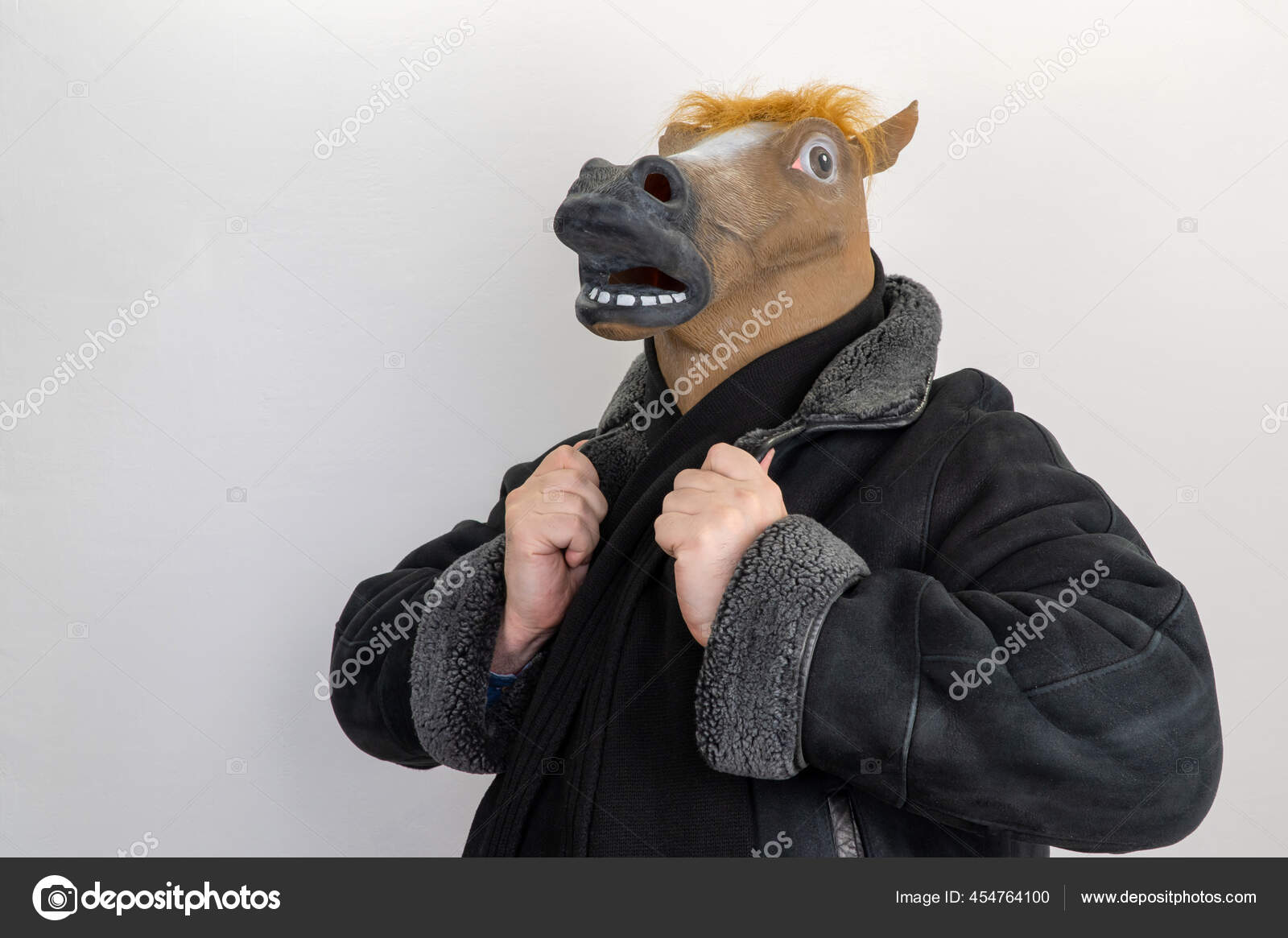 Man in a horse mask. selective focus. horse is wearing a coat. male