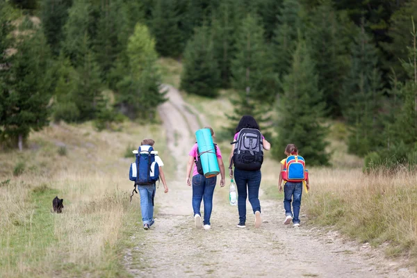 Family walk with backpacks from back — Stock Photo, Image