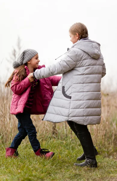 Sisters having fun in colorful autumn day — Stock Photo, Image