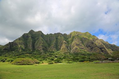 Kualoa Ranch cliffs under clouds