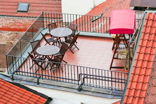 Balcony with furniture on a tiled roof — Stock Photo, Image