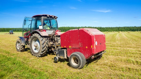 Agricultural machinery on the hay — Stock Photo, Image