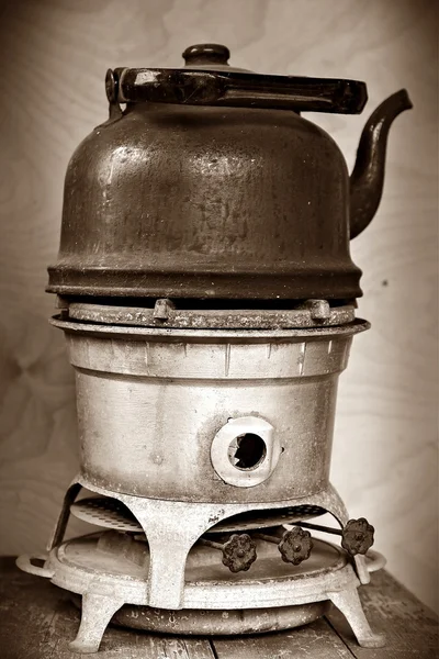 old kerosene stove with a sooty kettle