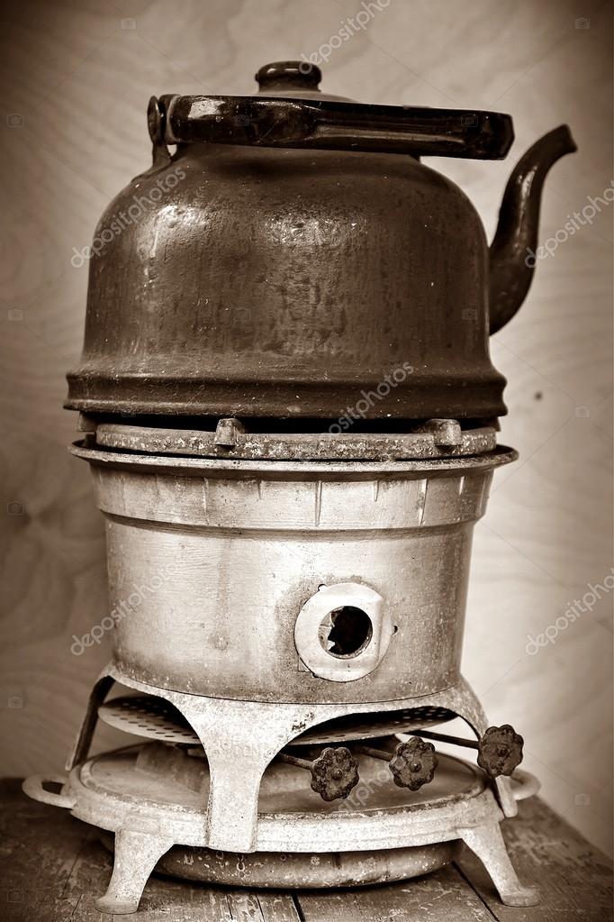 Old kerosene stove with a sooty kettle — Stock Photo © deb37 63752475