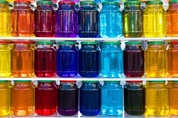 Glass jar with colored liquid — Stock Photo, Image