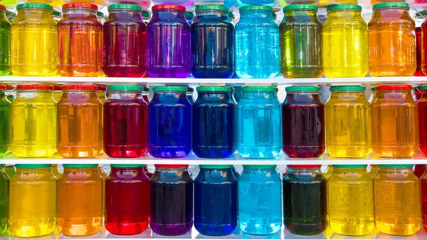 Glass jar with colored liquid — Stock Photo, Image