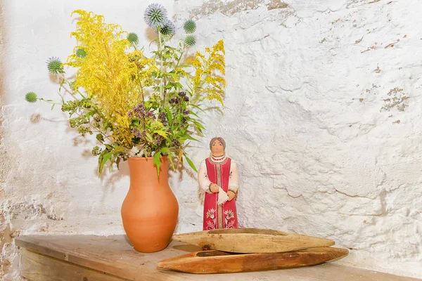 Jug with flowers and Russian clay toy — Stock Photo, Image