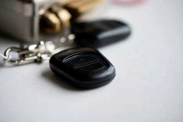 Remote key FOB to the electronic lock. In the background, a blurry fragment of the lock before it was installed. Selective focus.