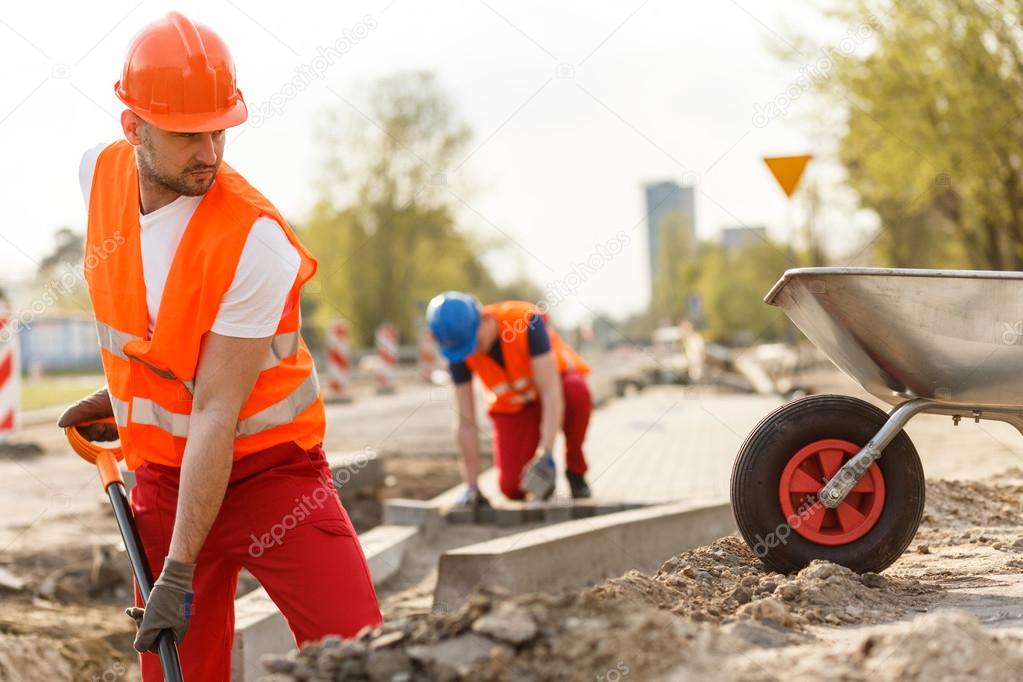 Strong construction worker digging