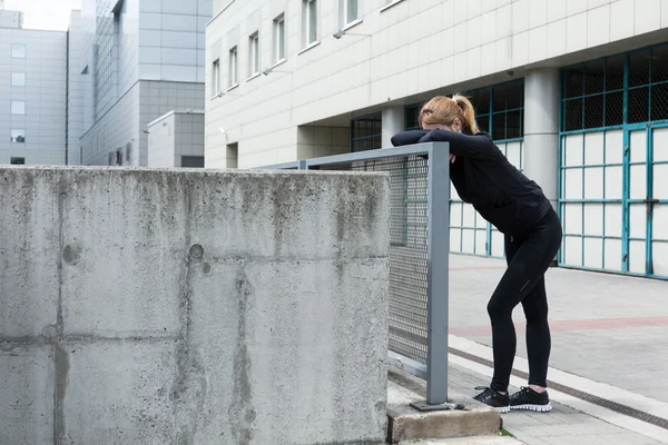 Runner stretching after workout — Stock Photo, Image