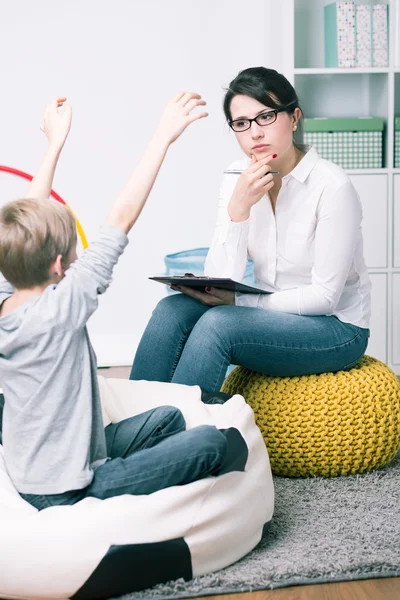 Concerned young psychologist and small patient — Stock Photo, Image
