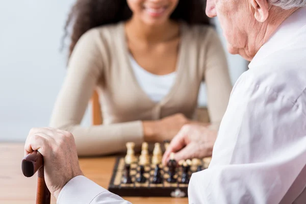 Carer, patient and duel in chess — Stock Photo, Image