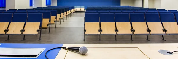 Microphone on a desk in classroom — Stock Photo, Image