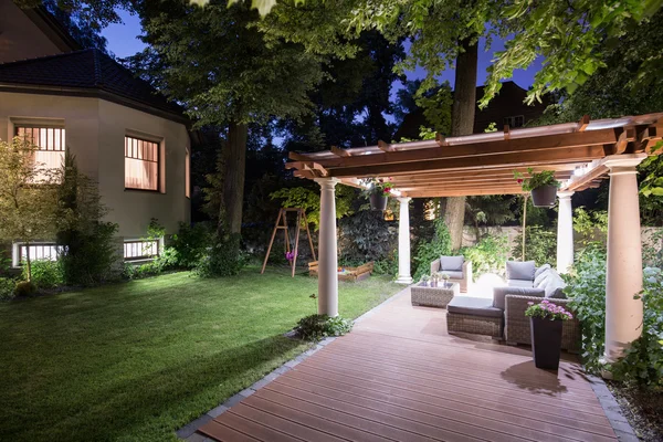 Garden with patio at night — Stock Photo, Image