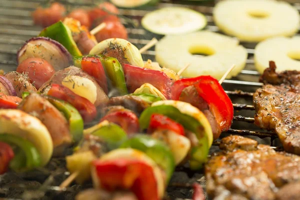 Shashliks and pineapple on grill — Stock Photo, Image