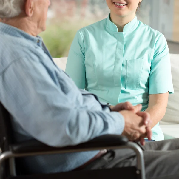 Senior man en jonge verpleegster — Stockfoto