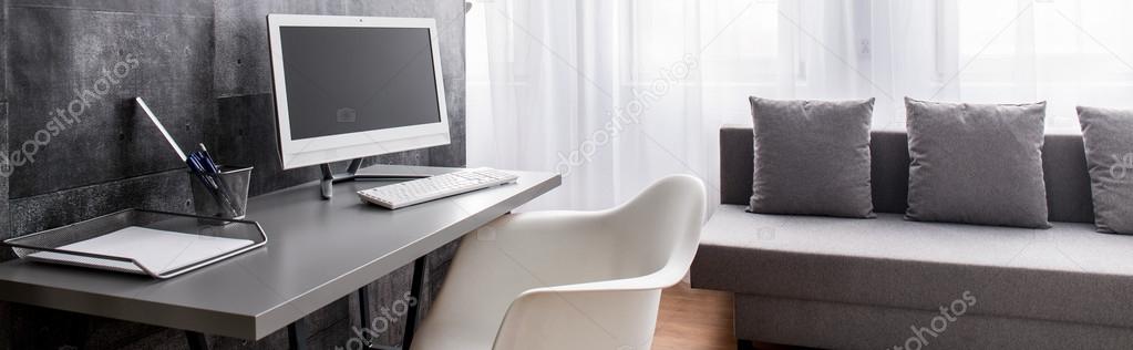 Stylish Office In Spacious Living Room Stock Photo
