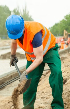 Worker digging ground  clipart
