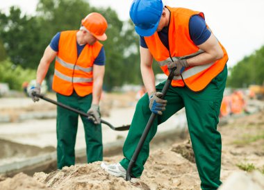 Men working together on road clipart