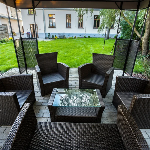 Wicker chairs on hotel's patio in garden — Stock Image Wicker chairs on hotel's patio in garden Royalty Free Stock Images