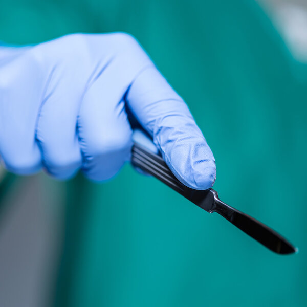 Hand of doctor holding scalpel