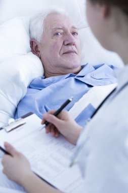 Nurse interviewing elderly patient clipart