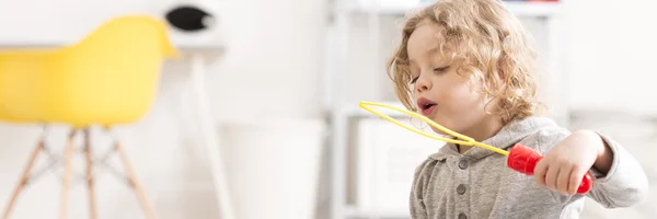 Boy blowing bubbles — Stock Photo, Image