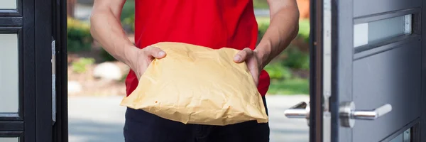 Bir paketi vererek teslimatçı — Stok fotoğraf